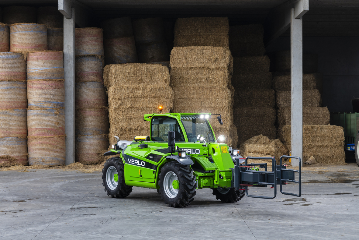 Merlo e-worker in agricultural setting equipped with a bale-handling attachment